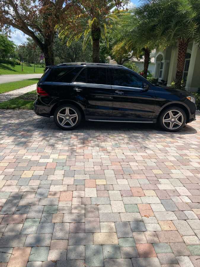 Side profile of a glossy black Mercedes SUV