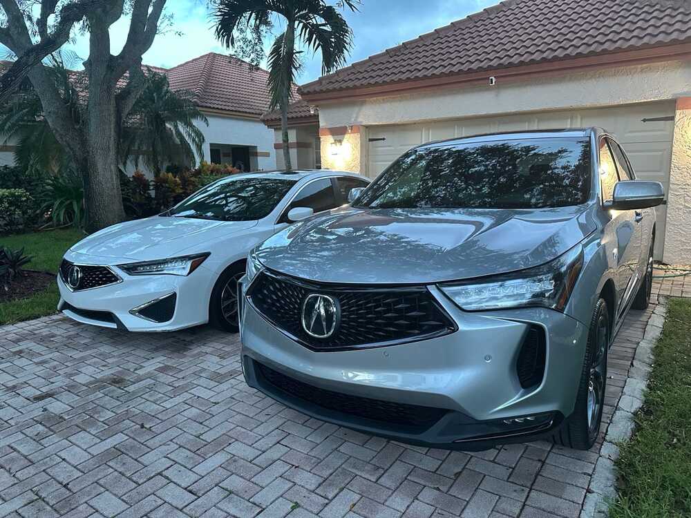 Two freshly detailed Acura vehicles in a driveway